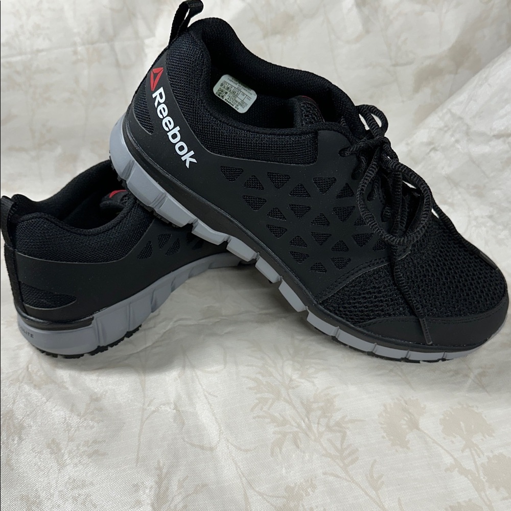 Brand new. Reebok Black and Gray Running Sneakers. Nonslip. 9 1/2. W No tag